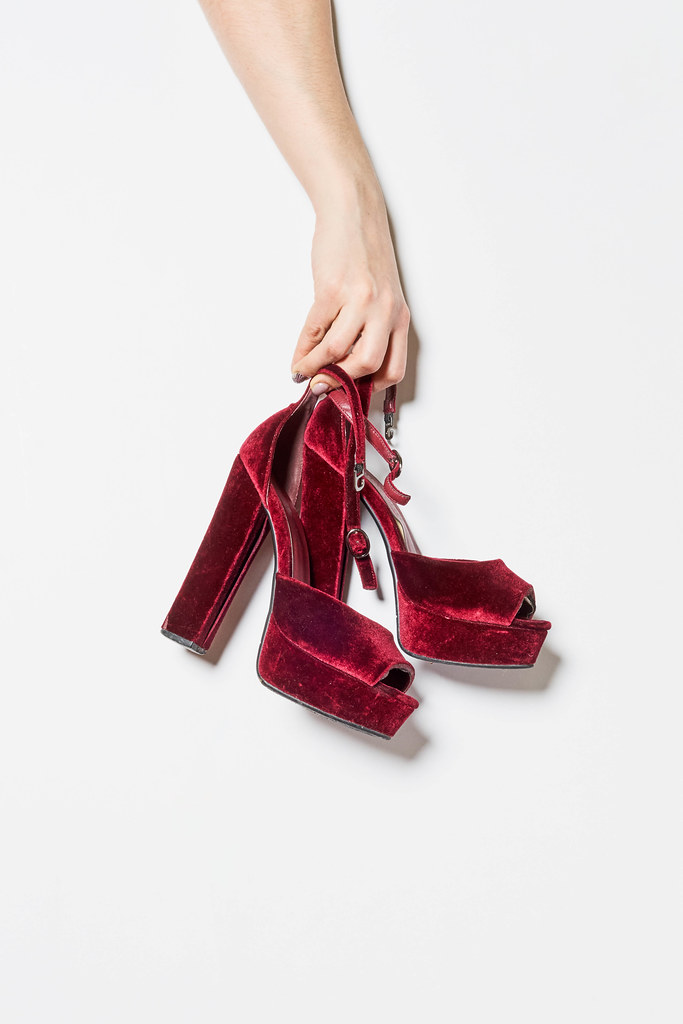 A girl picked up trendy red high hill shoes A girl picked up trendy red high hill shoes