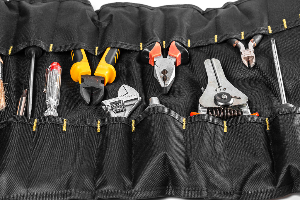 Background of various tools in black bag Background of various tools in black bag