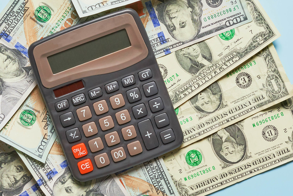 Business concept - calculator on money background Business concept - calculator on money background