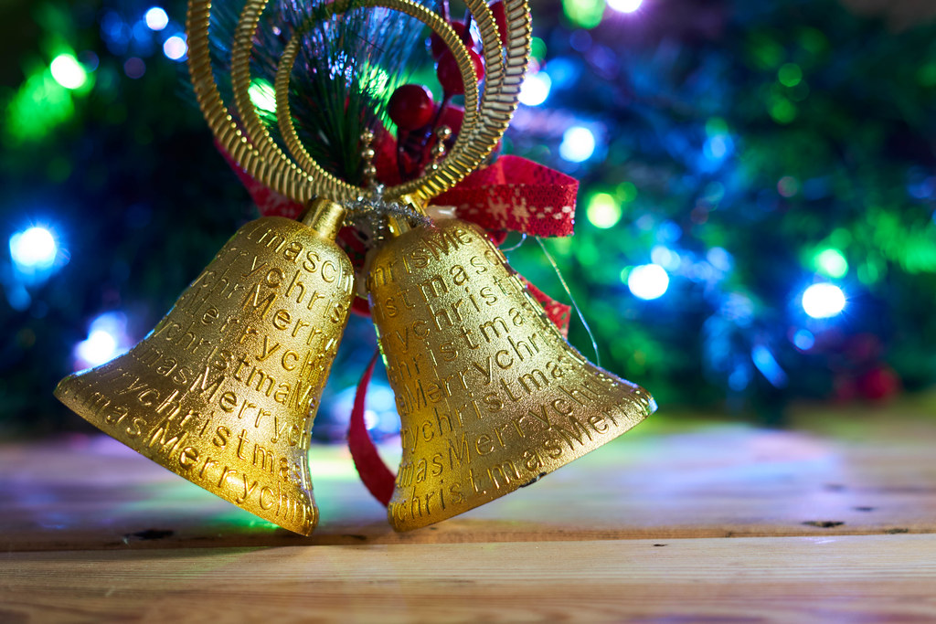 Close up of golden Christmas ornament against Xmas tree Close up of golden Christmas ornament against Xmas tree