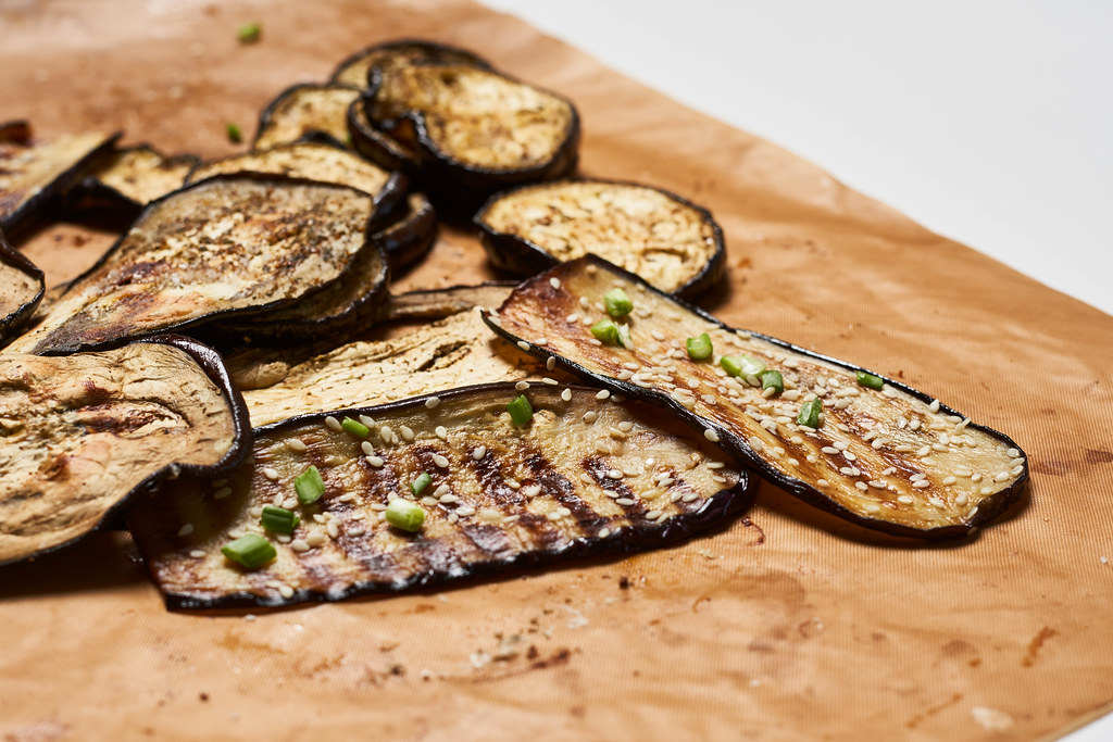 Grilled spicy eggplant slices on a cutting board Grilled spicy eggplant slices on a cutting board