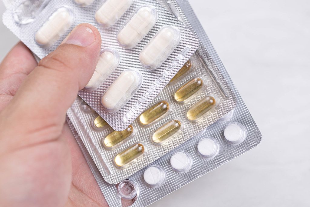 Immunity Tablets and Pills in the hand against Covid-19 virus Immunity Tablets and Pills in the hand against Covid-19 virus