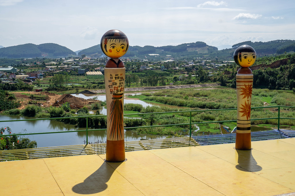 Japanese Themed Characters on a Sun Terrace with View of Mountains and a Village in the Background in Dalat, Vietnam Japanese Themed Characters on a Sun Terrace with View of Mountains and a Village in the Background in Dalat, Vietnam