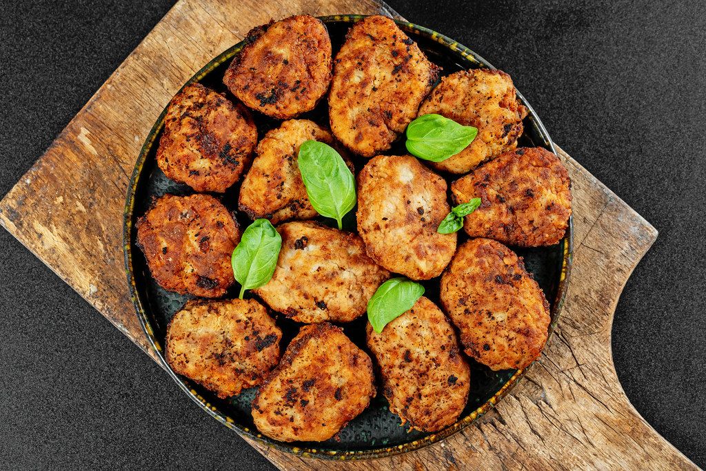 Juicy delicious meat cutlets on a old wooden kitchen board, top view Juicy delicious meat cutlets on a old wooden kitchen board, top view