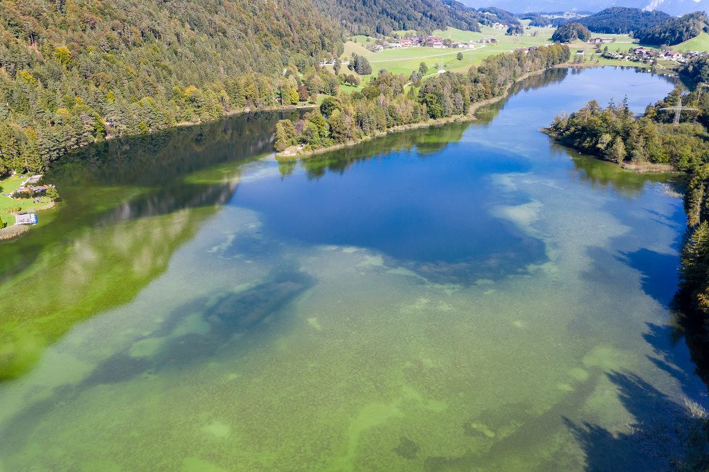 Lake Reintal: the largest of the Kramsach Lakes in the Alpbach Valley. Aerial view in autumn Lake Reintal: the largest of the Kramsach Lakes in the Alpbach Valley. Aerial view in autumn