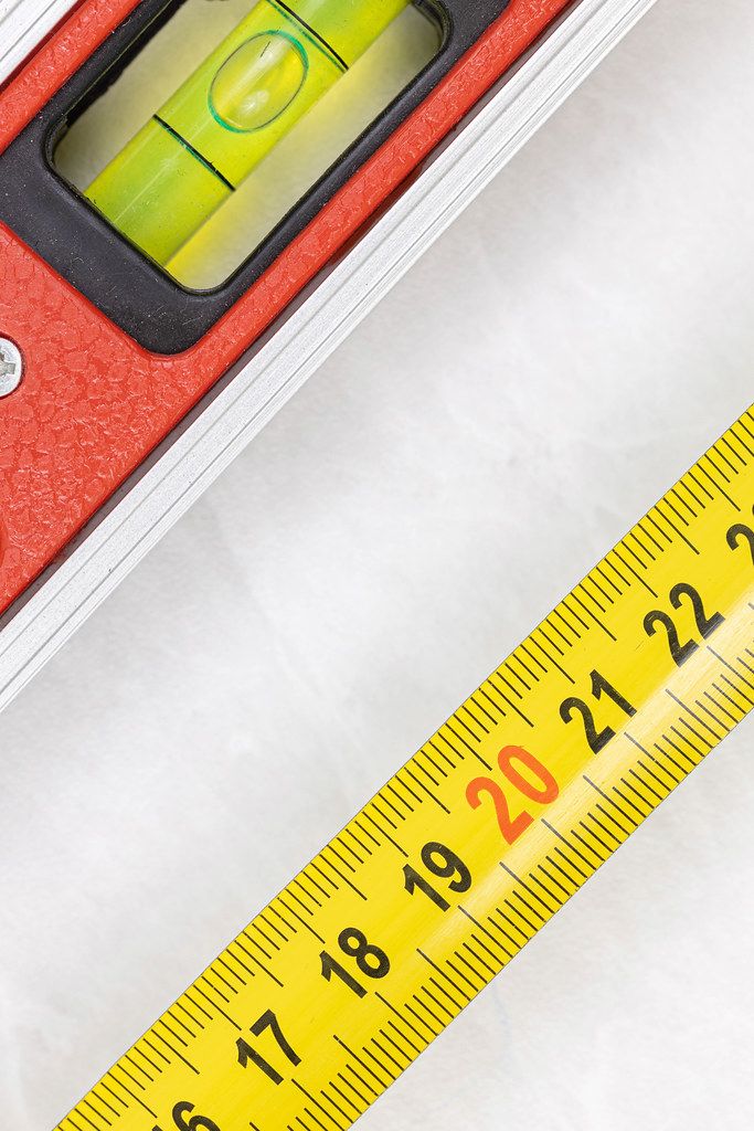 Measuring Tape with Level in Construction Concept with copy space Measuring Tape with Level in Construction Concept with copy space