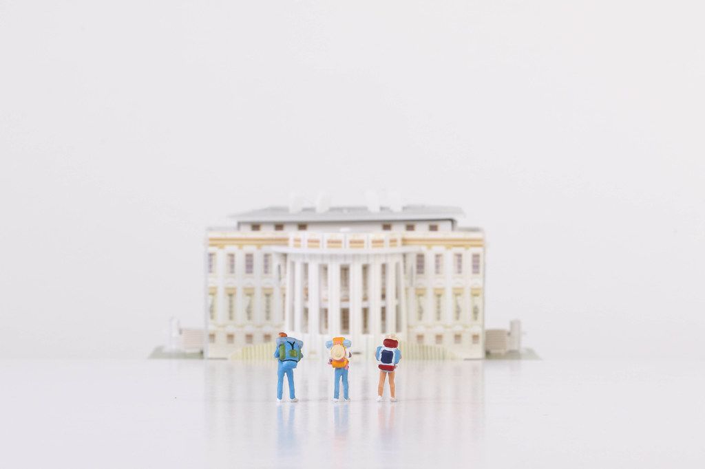 Miniature travelers stading in front of the White House Miniature travelers stading in front of the White House