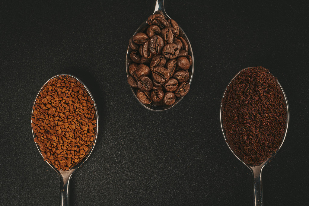 Soluble coffee, coffee beans and ground coffee isolated on black background, top view Soluble coffee, coffee beans and ground coffee isolated on black background, top view