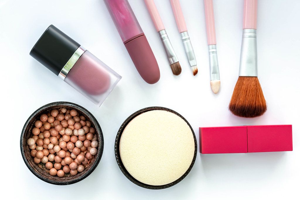 Top view, female cosmetics and brushes on a white background Top view, female cosmetics and brushes on a white background