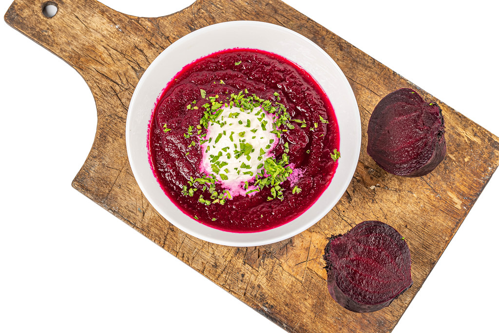 Veggie beetroot soup on old wooden kitchen board, top view Veggie beetroot soup on old wooden kitchen board, top view