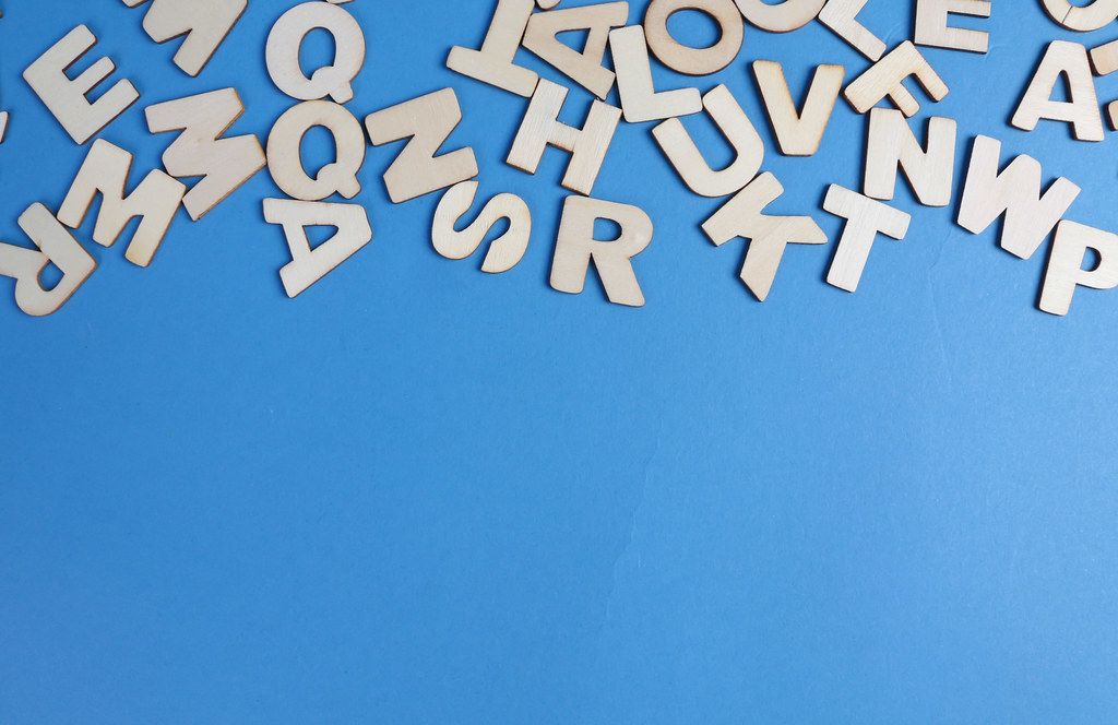 Wooden letters on blue background Wooden letters on blue background