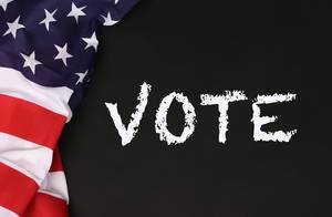 American flag with the text Vote against a blackboard background.jpg American flag with the text Vote against a blackboard background.jpg