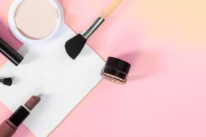 Beauty concept. Woman cosmetics accessories and white paper sheet on bright background Beauty concept. Woman cosmetics accessories and white paper sheet on bright background