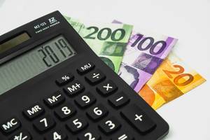 Calculator with peso bills on white background Calculator with peso bills on white background