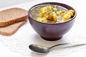 Chicken soup with dumplings, pieces of black bread with a spoon Chicken soup with dumplings, pieces of black bread with a spoon