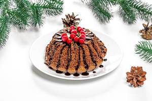Chocolate cupcake with red currants on Christmas background Chocolate cupcake with red currants on Christmas background