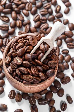 Coffee beans in a wooden bowl background Coffee beans in a wooden bowl background