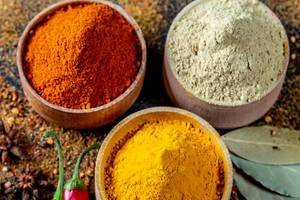 Colorful spices in wooden bowls on a dark background Colorful spices in wooden bowls on a dark background