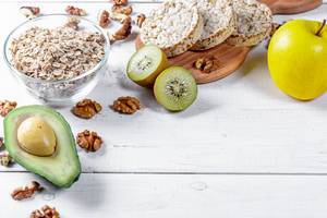 Concept diet - healthy food with muesli, avocado, kiwi and apple Concept diet - healthy food with muesli, avocado, kiwi and apple