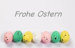 Easter eggs on white background with Frohe Ostern text Easter eggs on white background with Frohe Ostern text