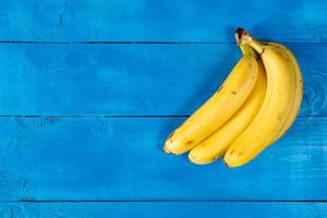 Fresh Bananas on the blue wooden table with copy space Fresh Bananas on the blue wooden table with copy space