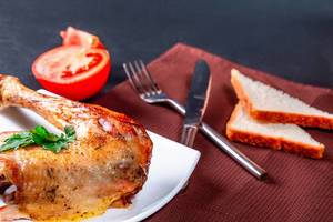 Fried chicken leg on a plate with Cutlery Fried chicken leg on a plate with Cutlery