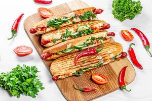 Grilled hot dogs with fresh vegetables, herbs and chili peppers Grilled hot dogs with fresh vegetables, herbs and chili peppers