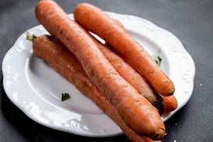 Group of carrots in a white plate, close up Group of carrots in a white plate, close up