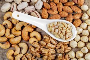 Healthy snack concept-nuts on a wooden background, top view Healthy snack concept-nuts on a wooden background, top view