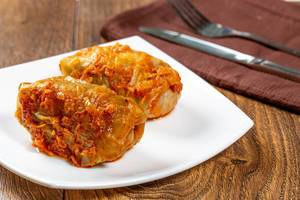 Homemade stuffed stewed in tomato sauce with knife and fork Homemade stuffed stewed in tomato sauce with knife and fork