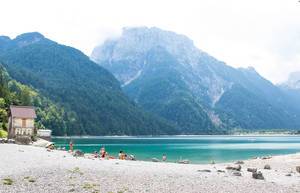 Lake Predil with turquoise water and mountains in background near Tarvisio in European Alps Lake Predil with turquoise water and mountains in background near Tarvisio in European Alps