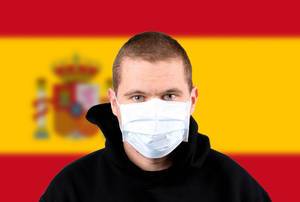 Man wearing protection face mask with flag of Spain Man wearing protection face mask with flag of Spain