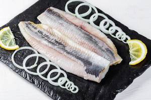 Marinated fish fillet with onion and lemon pieces Marinated fish fillet with onion and lemon pieces