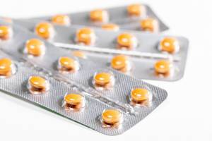 Orange pills close up. The concept of medicine, pharmacology Orange pills close up. The concept of medicine, pharmacology