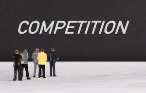 People standing in front of Competition text People standing in front of Competition text
