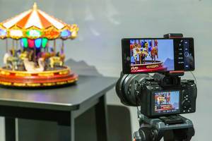 Picture quality and colour comparison: smartphone camera and photo camera take a picture of a vintage carousel music box