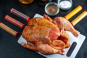 Raw chicken with natural spices on dark background Raw chicken with natural spices on dark background