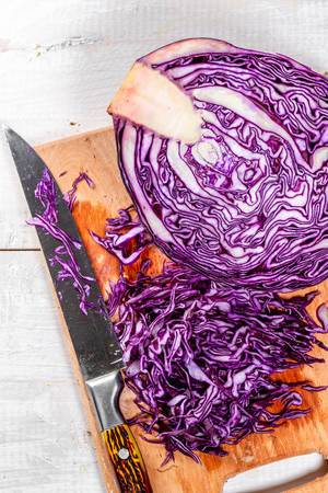 Red cabbage sliced on a kitchen Board with a knife Red cabbage sliced on a kitchen Board with a knife