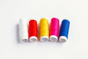 Set of colorful sewing threads on white background Set of colorful sewing threads on white background