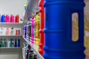 Shelf with plastic sport bottles of different shapes, sizes and colors - FIBO Cologne 2018 Shelf with plastic sport bottles of different shapes, sizes and colors - FIBO Cologne 2018