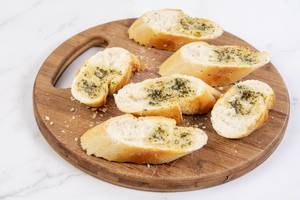 Sliced Baguettes served on the wooden board Sliced Baguettes served on the wooden board