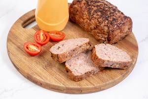 Sliced Pork and Chicken Meat Loaf with Tomatoes on the board Sliced Pork and Chicken Meat Loaf with Tomatoes on the board