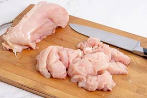 Sliced Raw Chicken meat on the cutting board Sliced Raw Chicken meat on the cutting board