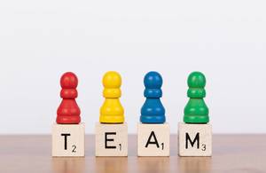 Team concept with four pawn figurines Team concept with four pawn figurines