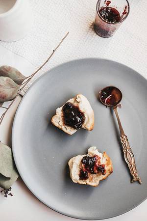 Top view of english brunch- homemade scones with jam on grey plate Top view of english brunch- homemade scones with jam on grey plate