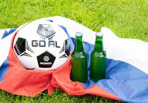 Two beer bottles with soccer ball on Russian flag Two beer bottles with soccer ball on Russian flag