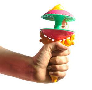 Woman hand holding newborn babies toy or rattle. Isolated on white. Woman hand holding newborn babies toy or rattle. Isolated on white.