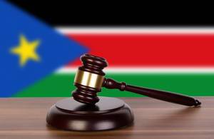 Wooden gavel and flag of South Sudan Wooden gavel and flag of South Sudan