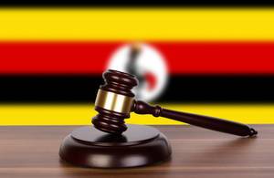 Wooden gavel and flag of Uganda